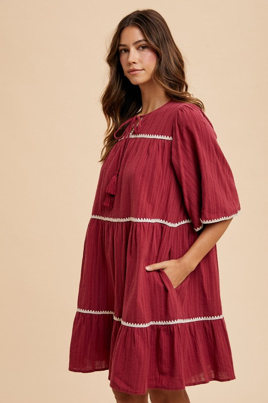 Tassel Contrast Trim Tie Neck Half Sleeve Tiered Dress – Bohemian-Inspired Dress with Tassel Details, Adjustable Tie Neck, and Tiered Design for a Flowing, Feminine Silhouette