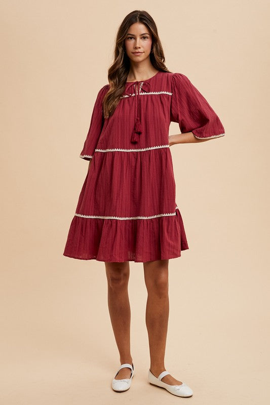 Tassel Contrast Trim Tie Neck Half Sleeve Tiered Dress – Bohemian-Inspired Dress with Tassel Details, Adjustable Tie Neck, and Tiered Design for a Flowing, Feminine Silhouette